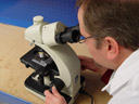 Designer using a microscope